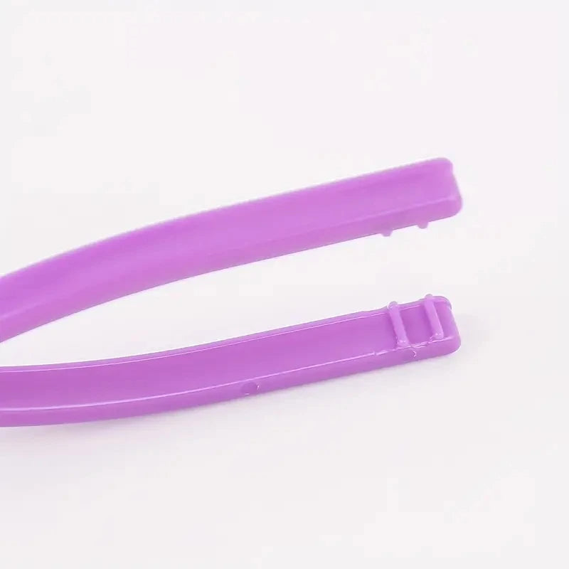 Close-up of a purple plastic tweezer on a white background, perfect for detailed sewing tasks and organizing with the 50 Pcs Bobbin Clips for Thread Spools.