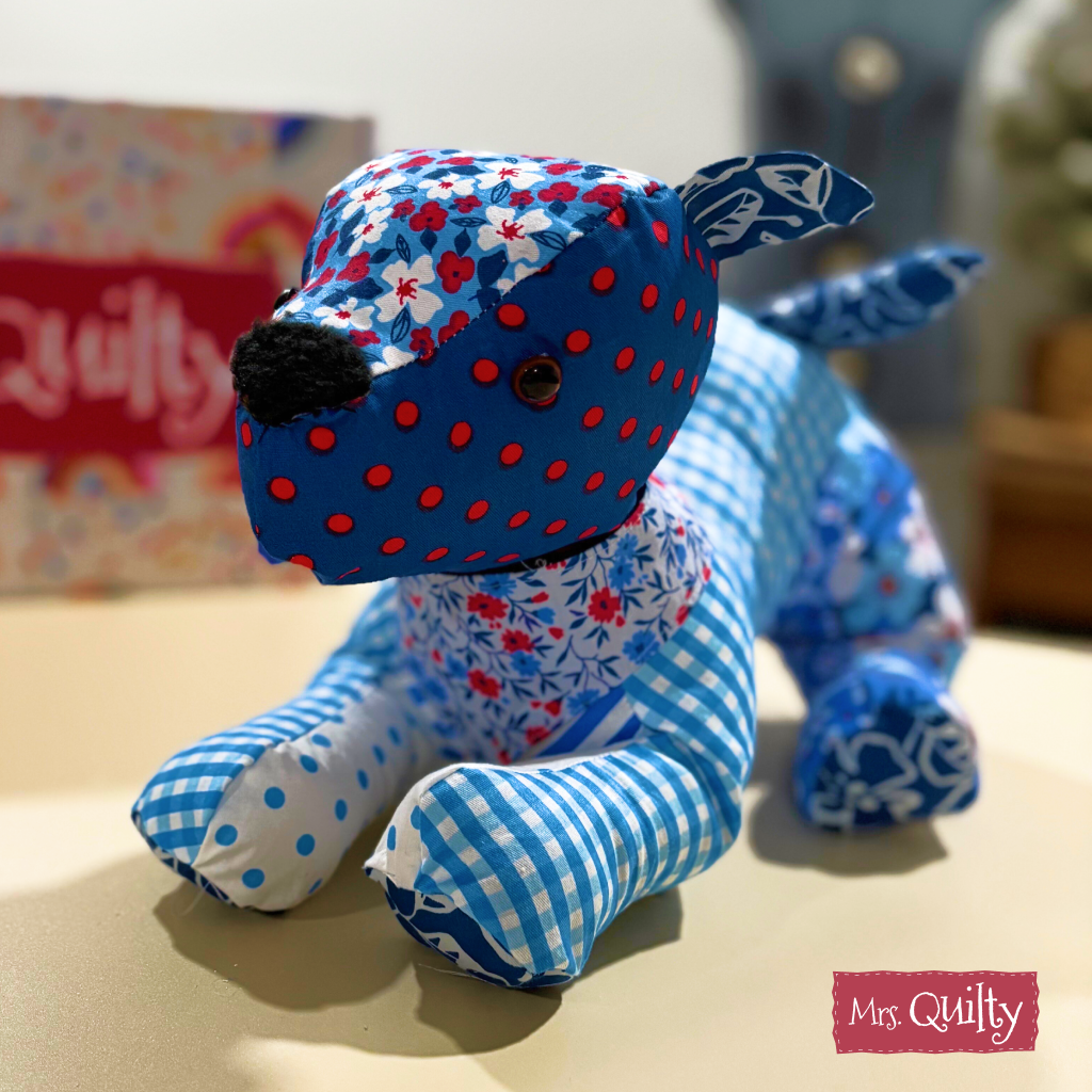 Pennie the Puppy, a beginner-friendly downloadable PDF quilt pattern, features a patchwork stuffed dog in blue and red fabrics—perfect inspiration for your next quilting project.