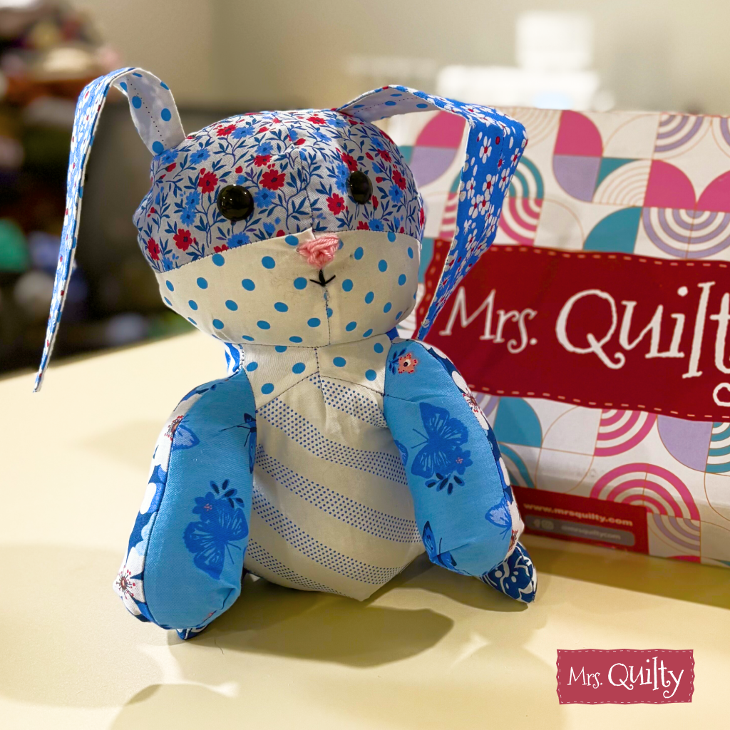 Bonnie the Bunny Downloadable PDF Quilt Pattern lets you create a unique fabric bunny with blue, white, and floral patterns—perfect for crafters looking for charming handmade gift ideas.