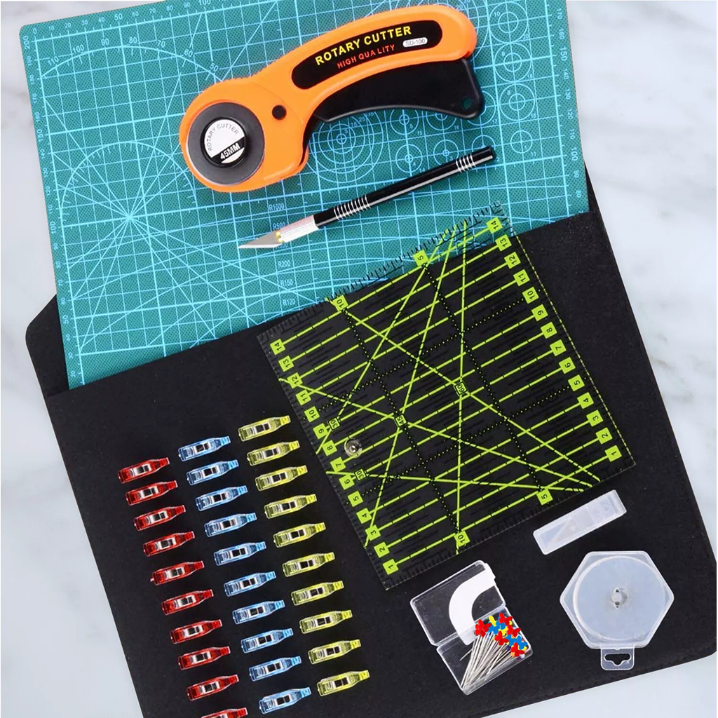The 97-Piece Quilting Kit: Perfect for Beginners includes a rotary cutter, quilting ruler, precision knife, cutting mat, sewing clips, straight pins, and measuring tape—essential tools neatly arranged for new quilters.