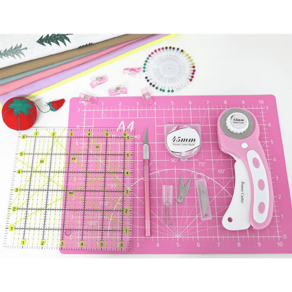 Quilting tools neatly organized on the cutting mat for easy crafting.