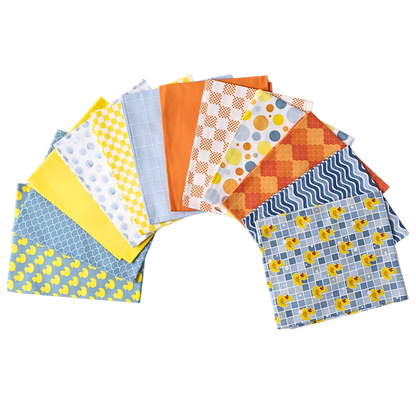 A fan arrangement of blue, yellow, orange, and white patterned squares features playful duck prints and geometric designs from The Ducky Day - Fat Quarter Bundle, made with 100% cotton quilting fabric on a white background.