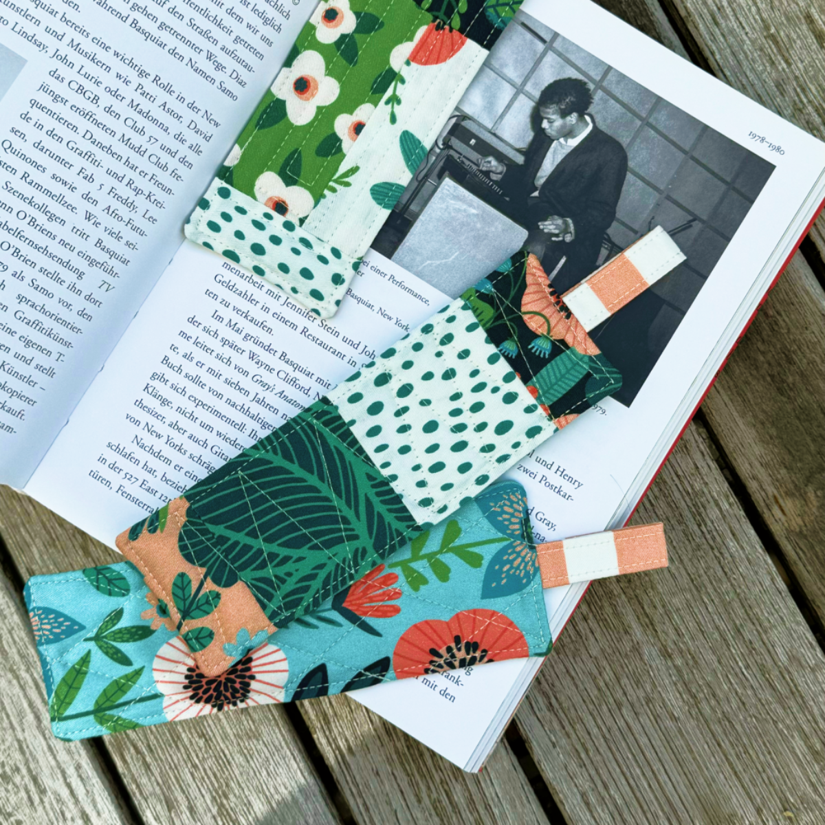 The Bookmark Downloadable PDF Quilt Pattern features colorful floral and leaf quilt designs—ideal for beginner-friendly sewing projects. Perfect for adding a handmade touch to your reading experience!.