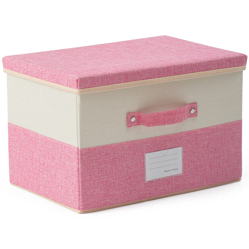 The Foldable Storage Box with Lid offers a durable and stylish storage solution in pink and beige fabric, featuring a handle and front label slot, perfect for any room.
