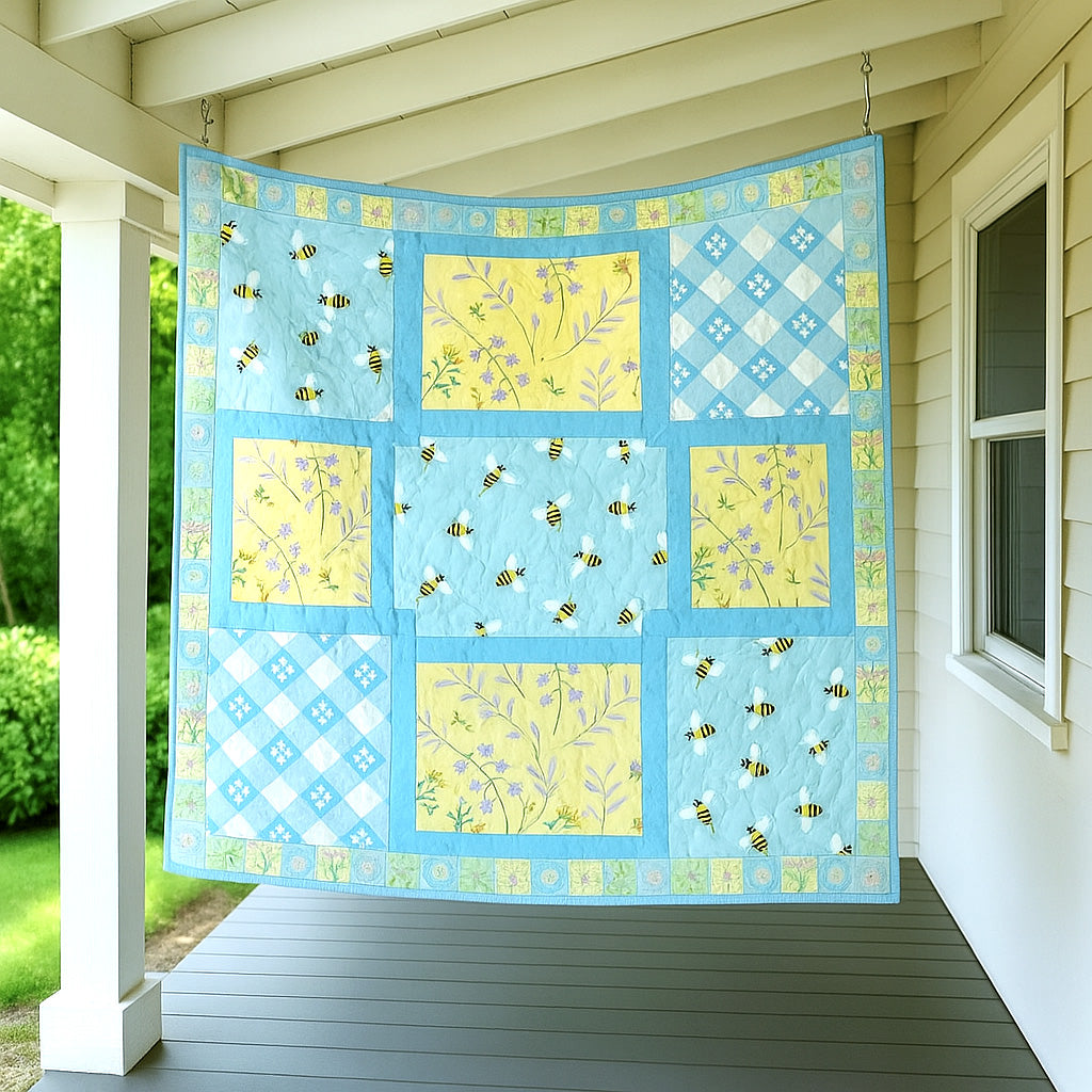 A Bundle of 14 Quilt Patterns featuring vibrant blue and yellow florals and bee designs hangs on a porch by a white house—perfect inspiration for beginner quilting enthusiasts.