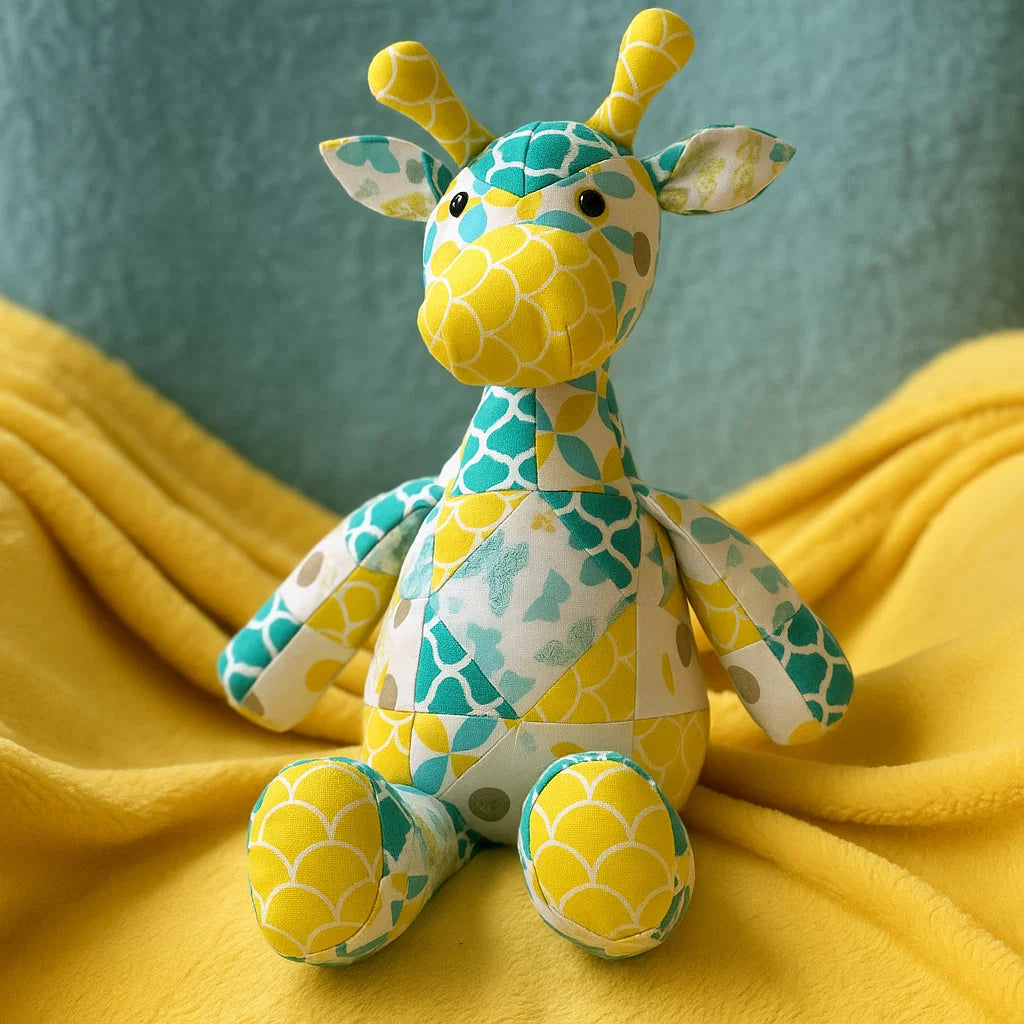 Stuffed giraffe toy with a pattern on a yellow blanket against a teal background