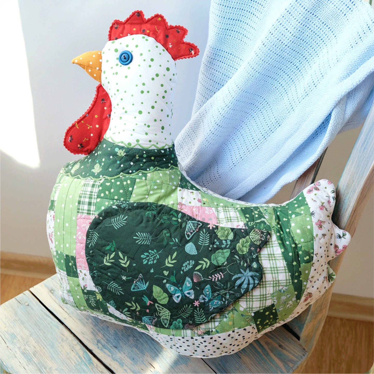 Mrs. Quilty Plushies – Bundle of 14 Quilted Patterns features charming designs like a patchwork fabric chicken pillow with a red comb—perfect inspiration for crafting handmade stuffed animals and quilted plushies.