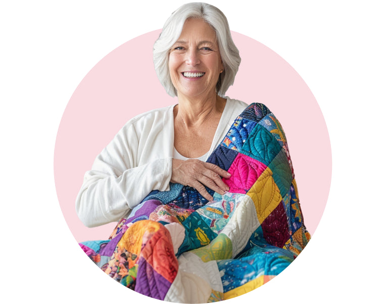 A smiling quilter holding a colorful handmade quilt