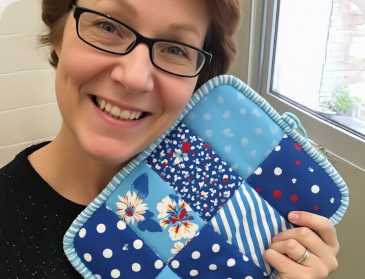 Liana showing the quilted pieces she made